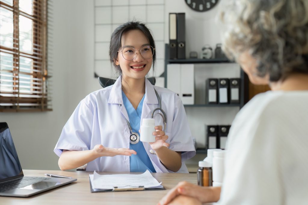 Primary care physician in West Palm Beach talking with an elderly patient during a consultation