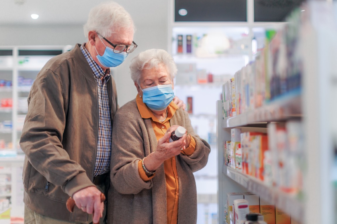 Senior couple looking for medicine in a pharmacy store.